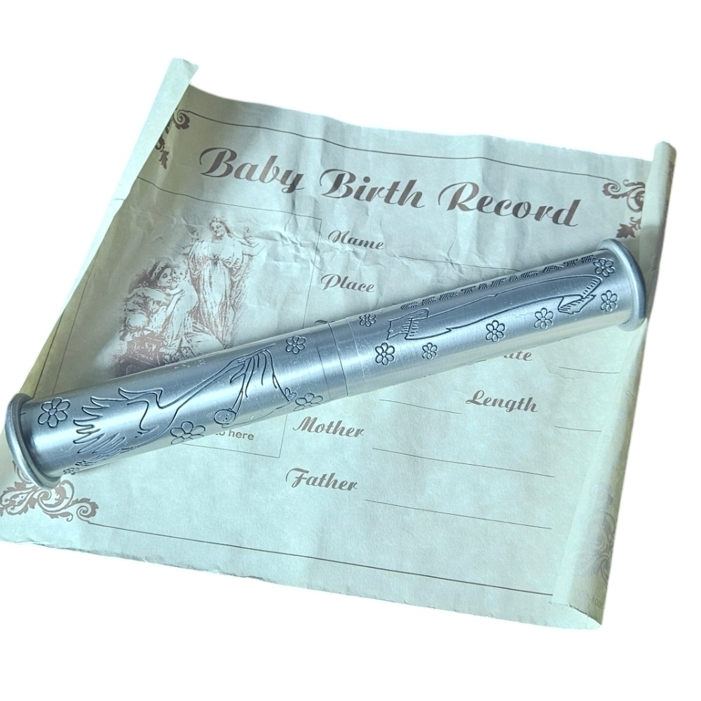 A pewter silver birth certificate holder a baby keepsake.